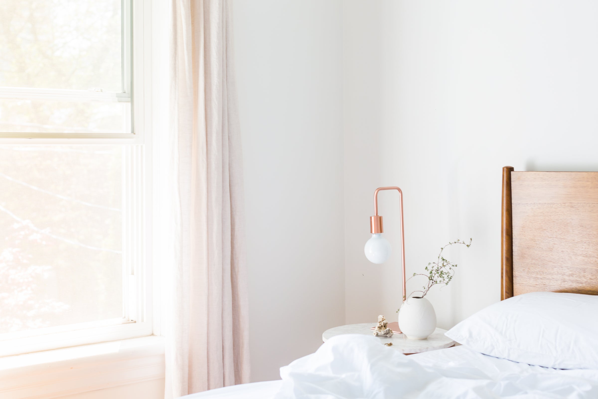 Bright bedroom with a set of white bed linen
