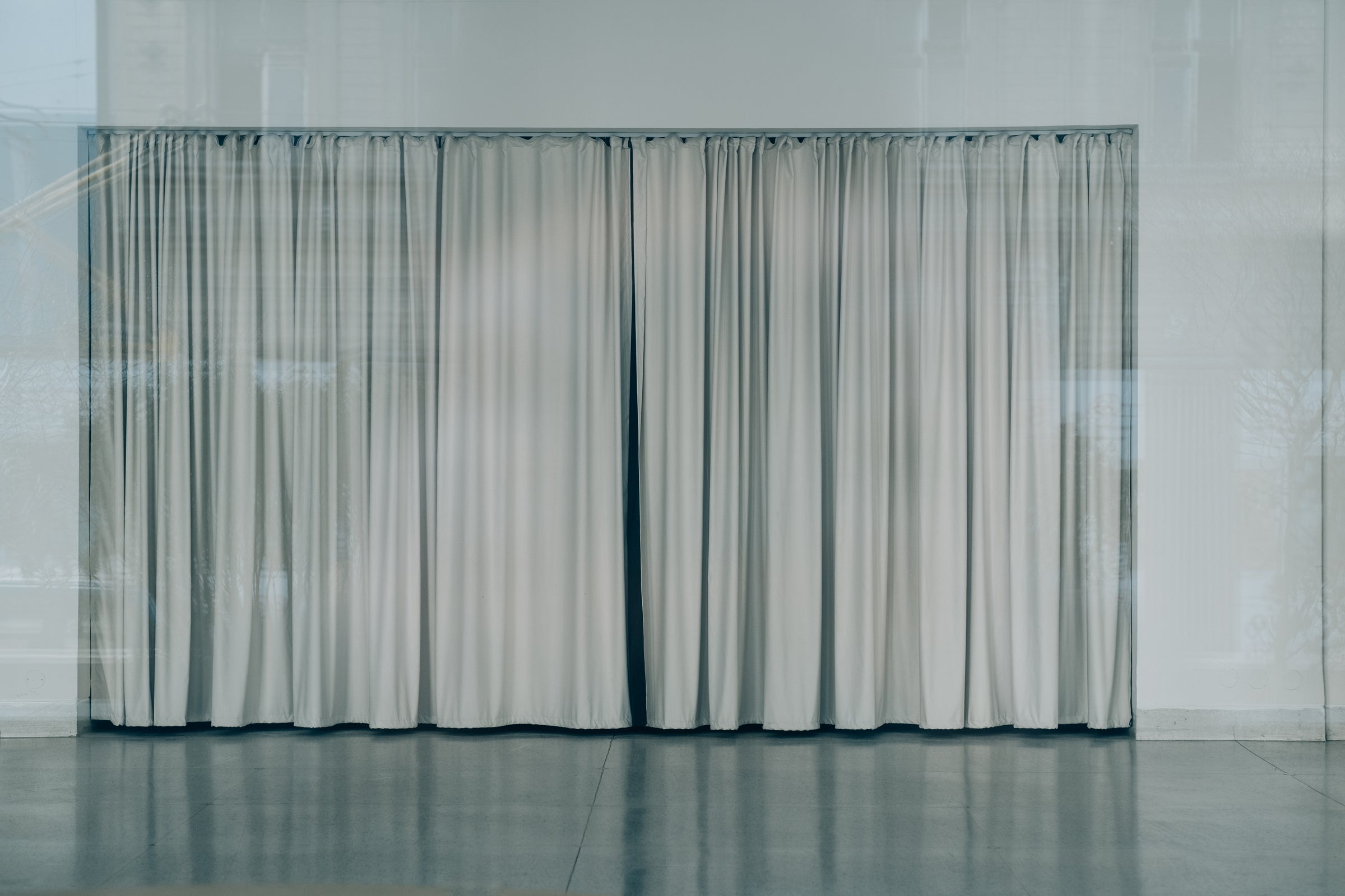 A run of neutral-toned curtains in an interior
