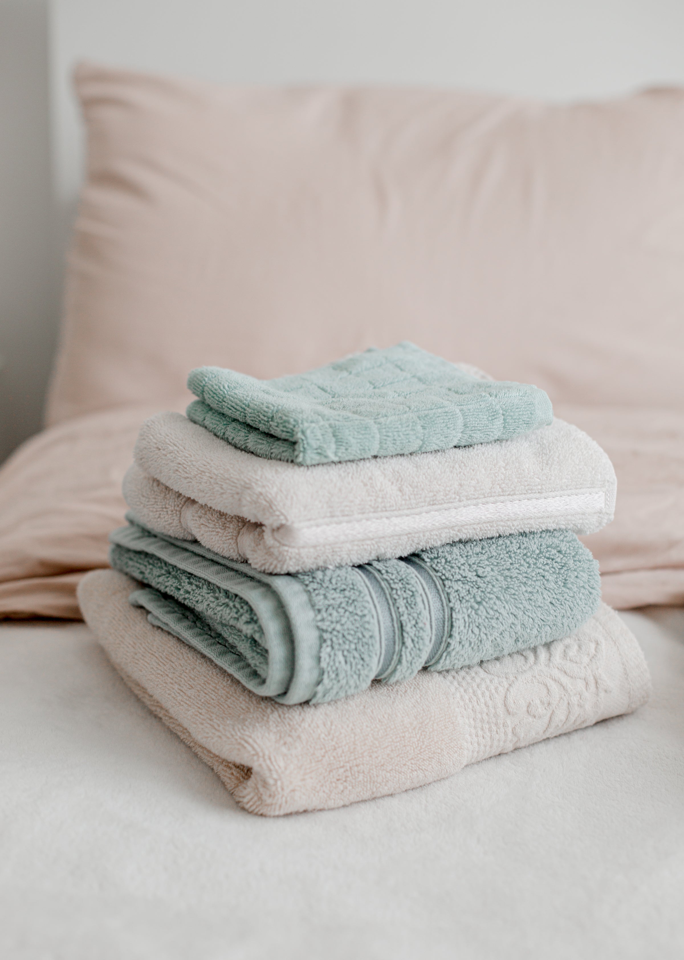 Stack of folded terry towels in several formats