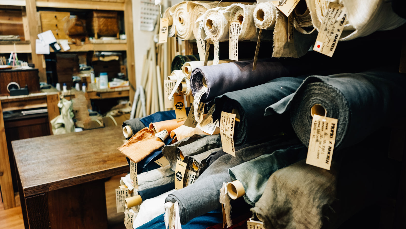 Rolls of upholstery cloth stacked on shelves